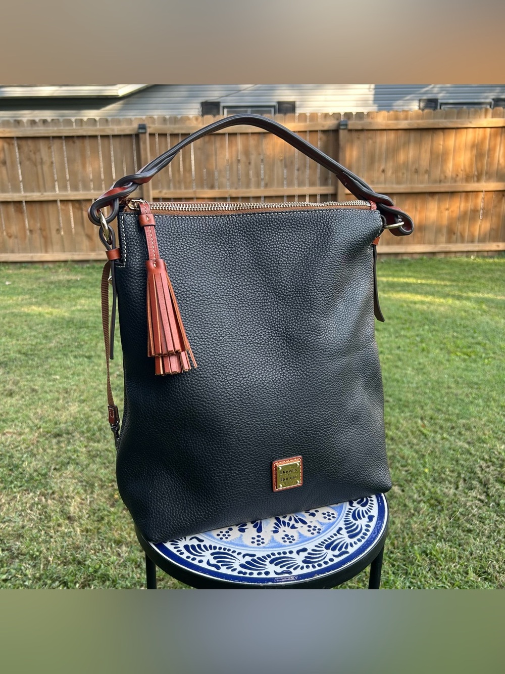 Dooney & Bourke Black Pebbled Leather Shoulder Bag with Brown Trim and Tassel